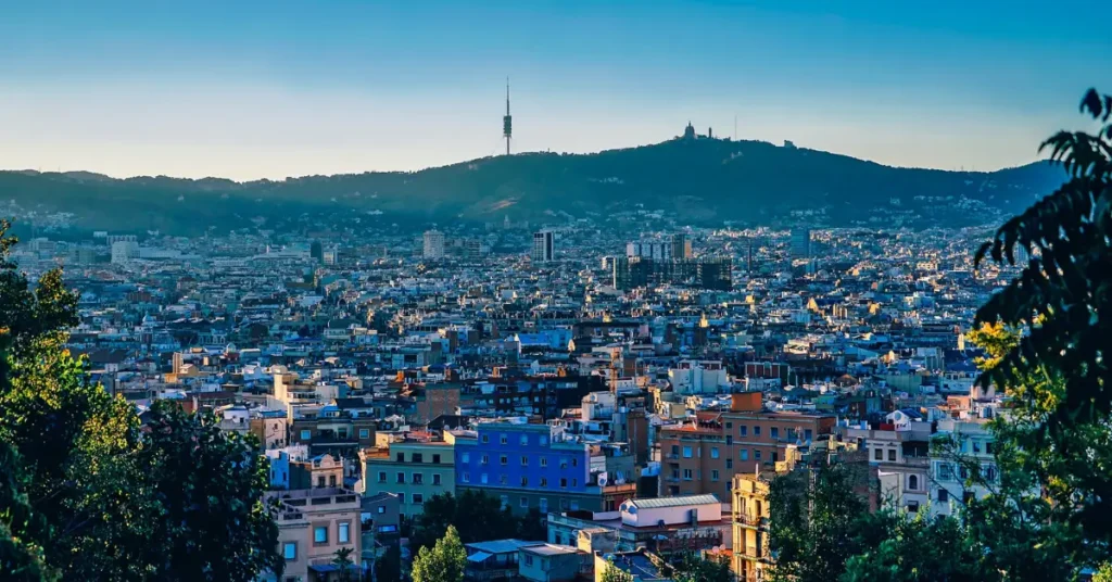 
A-panoramic-vista-of-Barcelonas-cityscape-bathed-in-warm-Mediterranean-sunlight